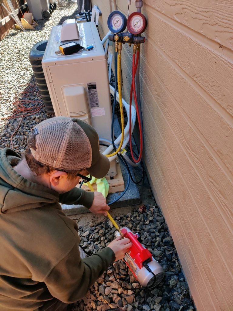 Air conditioner getting repaired by technician 